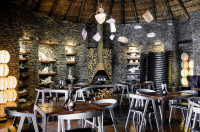 Main dining area at Singita Boulders - decor inspired by the surrounding landscape 