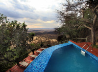Swimming pool with a sun lounging deck at Mbali Mbali Soroi Serengeti Lodge 