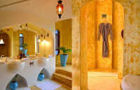 Matemwe Retreat - Main bathroom with dual view of vanity and shower