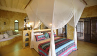 Matemwe Retreat - Main bedroom with cultural inspired decor