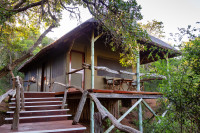 The luxury safari tents perched high on thatched platforms at “tree top” level are joined by raised walkways and offer spectacular views over the thickly-wooded valley.