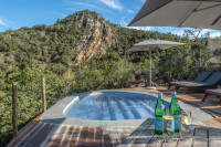 Guests can relax around the pool and enjoy breathtaking views of the cliff face.