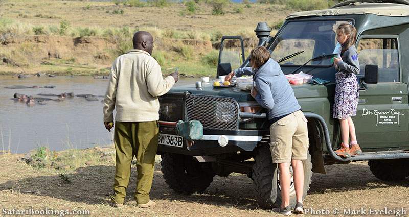 Family enjoying a snack-stop in the heart of the Masai Mara