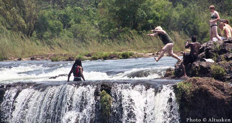 Tourists jumping into Devil's Pool, Victoria Falls