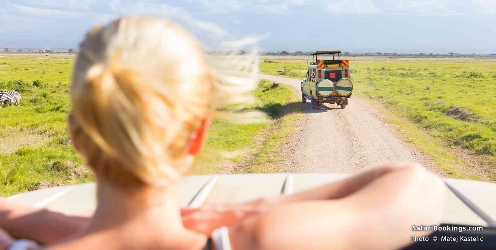 Safari vehicles crossing the open plains