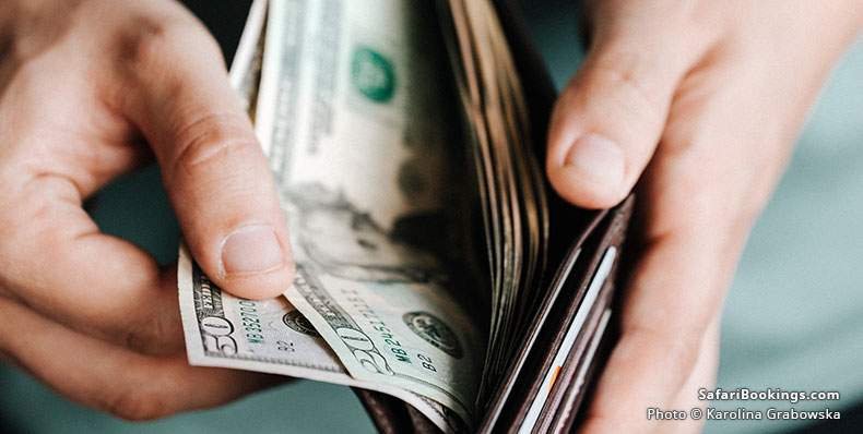 Man getting dollars from a wallet