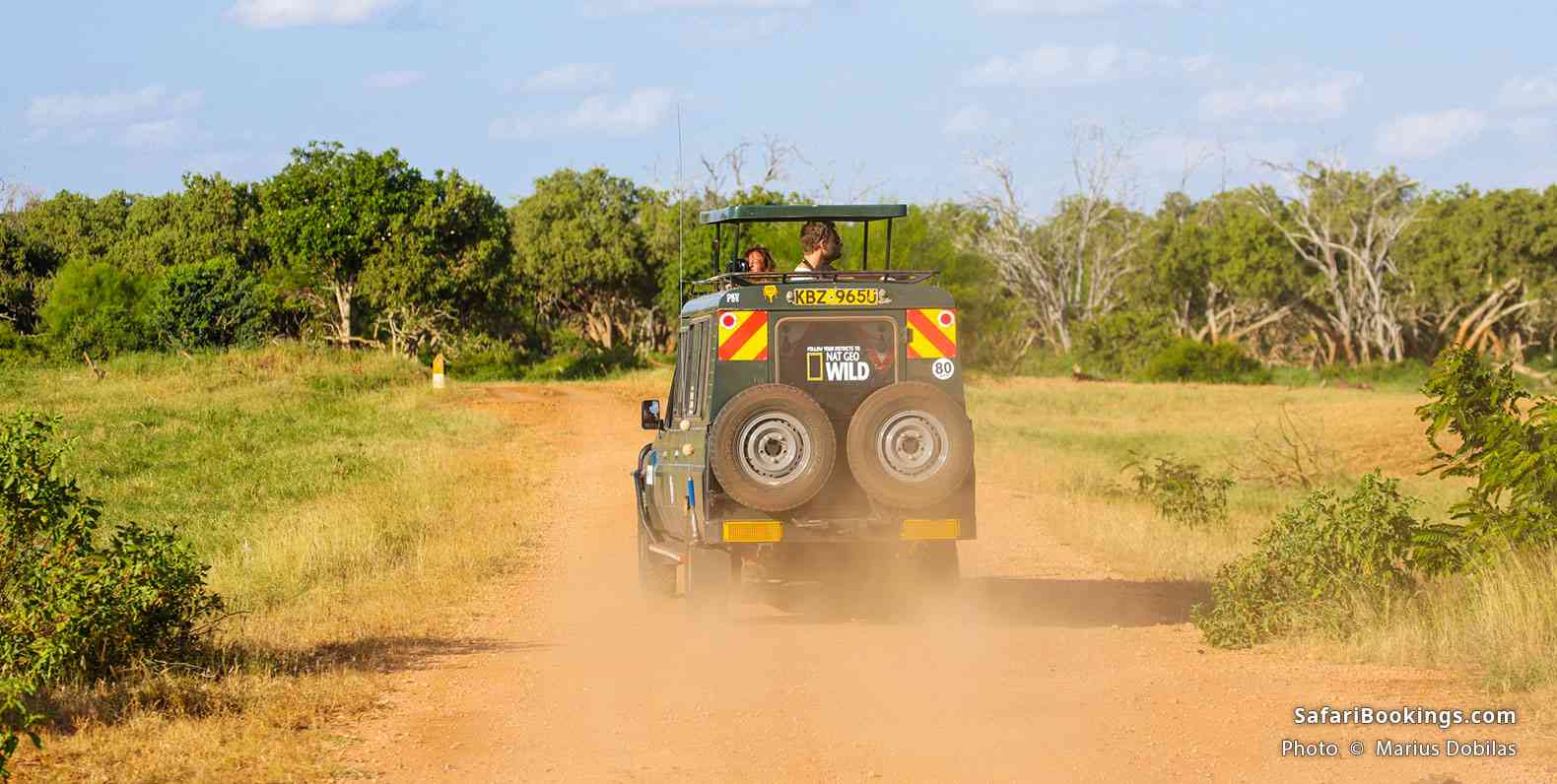 Safari vehicle on a dusty road