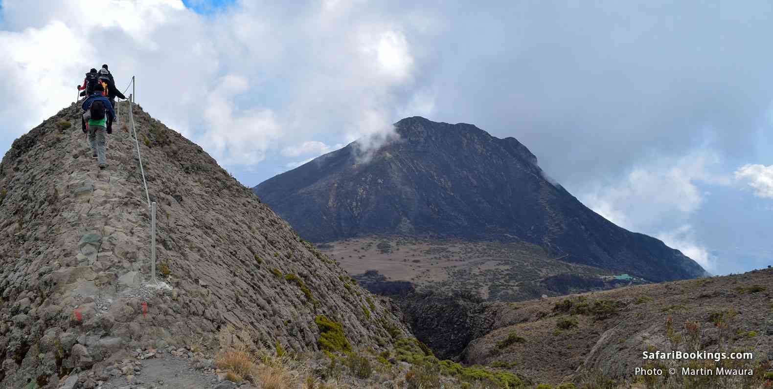 Hikers on Mt Meru with a backdrop of Little Meru