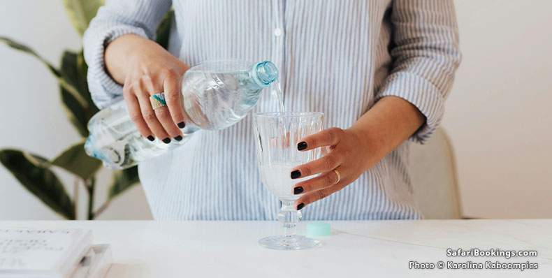 Woman pouring water into a glass