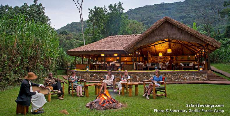 Guests at Sanctuary Gorilla Forest Camp sitting around a fire