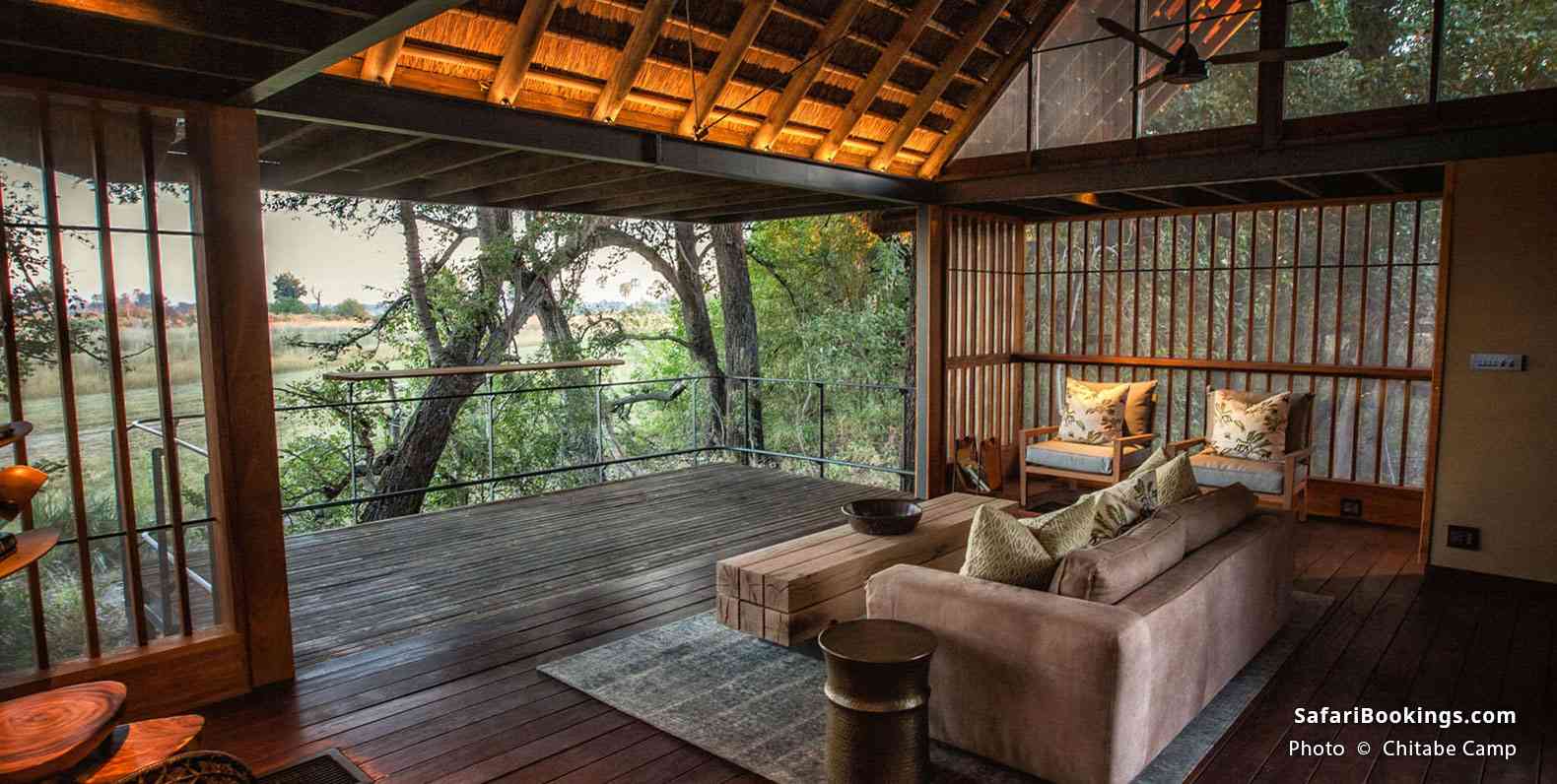 An elegant open-air lounge with wooden decor and bush views offers a serene retreat at Chitabe Camp