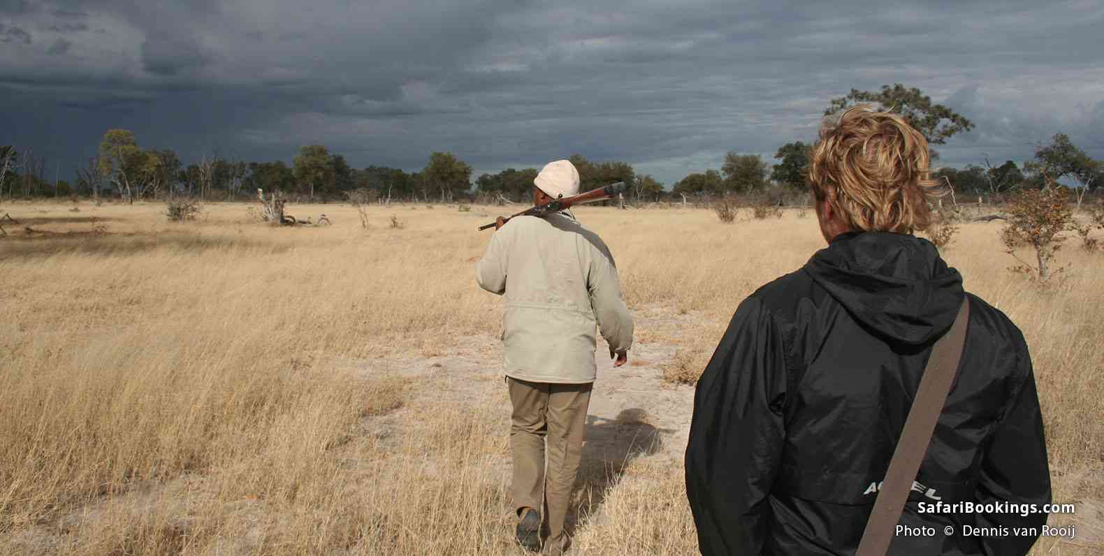 An armed guide leads a walking safari