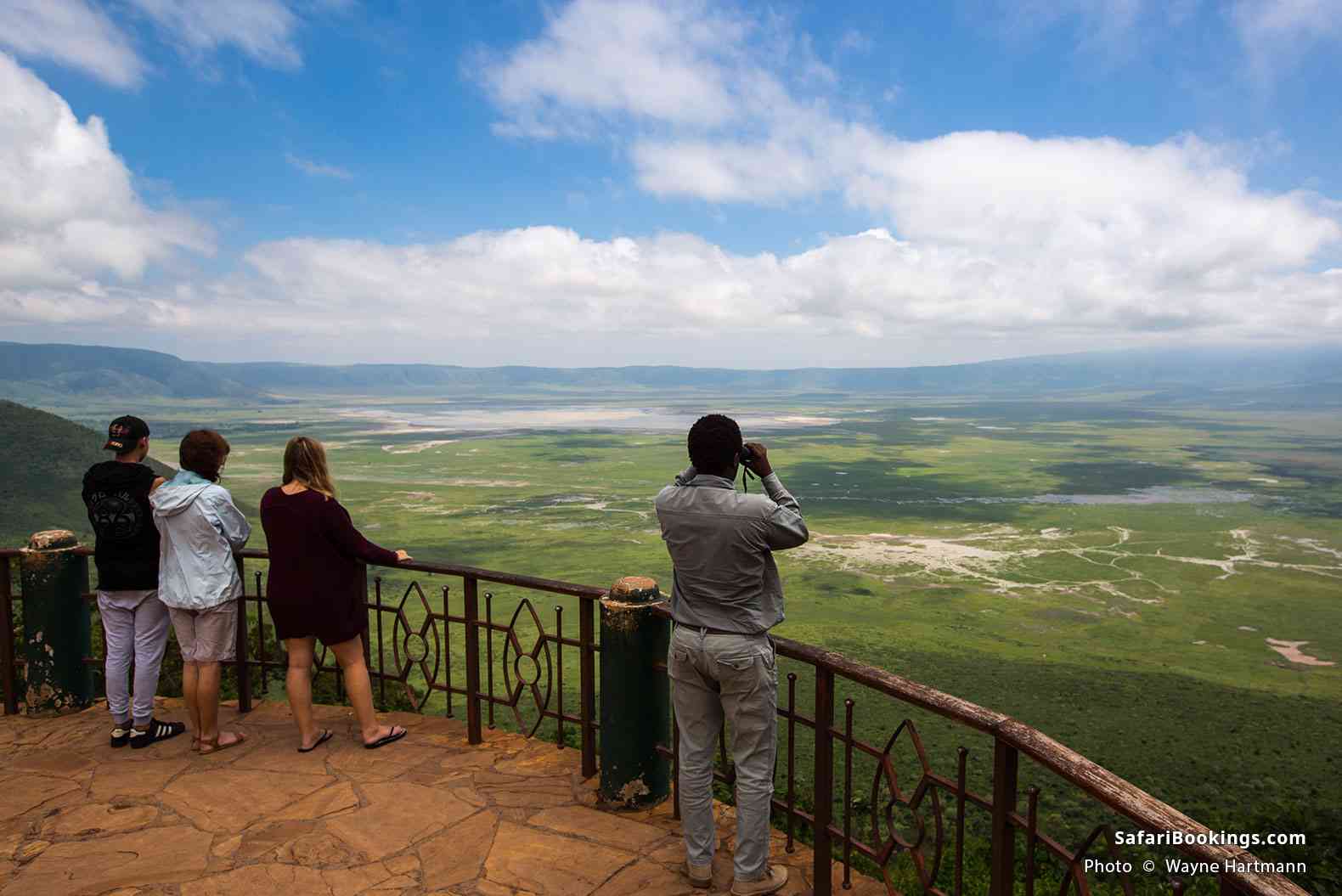 Travelers looking over the Ngorongoro Crater from a lodge terrace