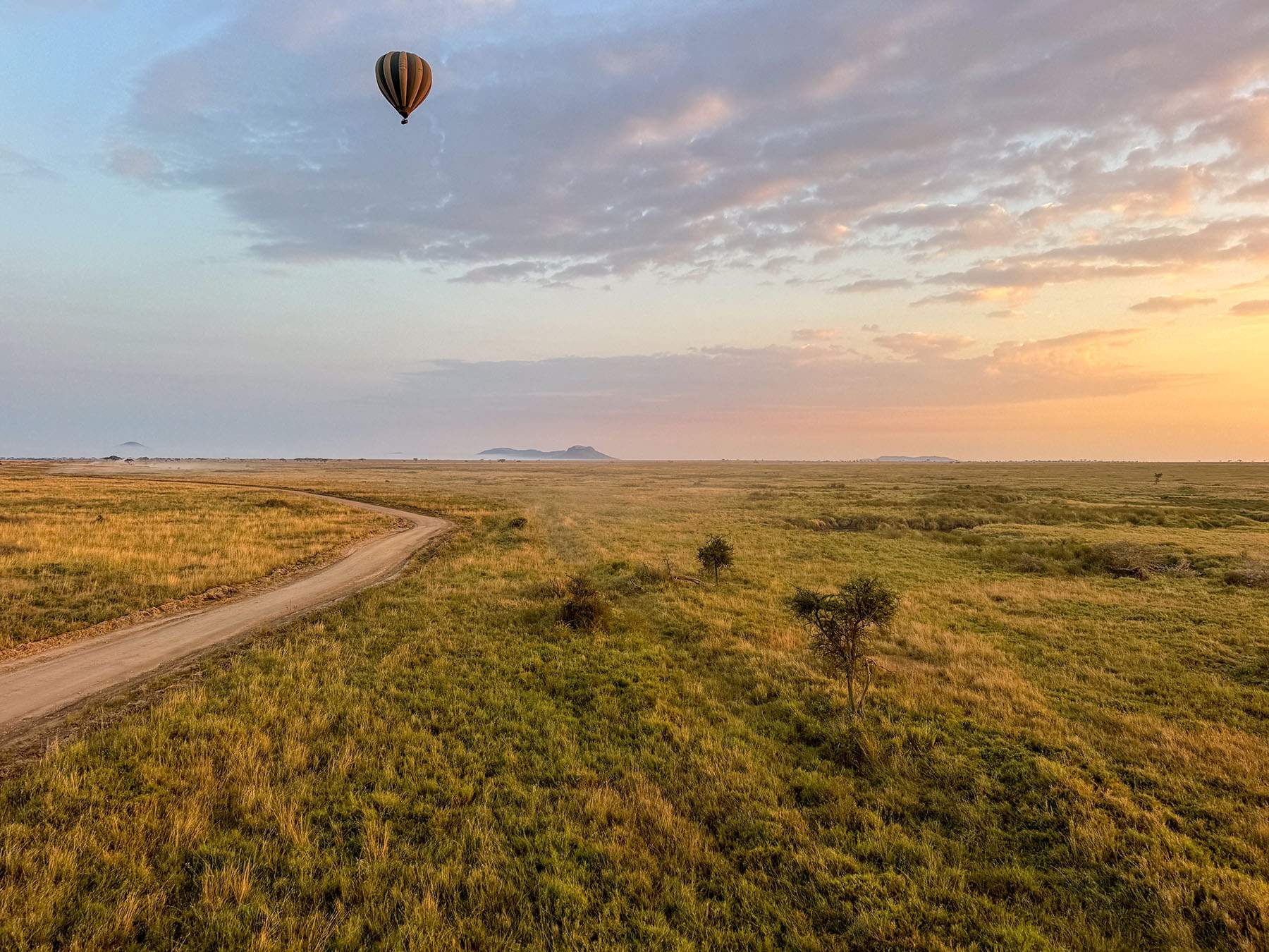 A hot-air balloon drifting over the Serengeti plains