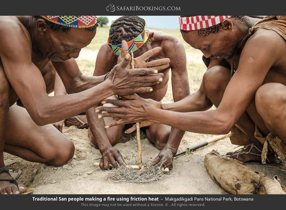 Traditional San people making a fire using friction heat in Makgadikgadi Pans National Park, Botswana