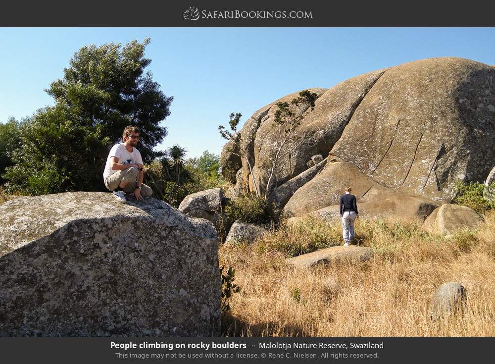 People climbing on rocky boulders in Malolotja Nature Reserve, Eswatini