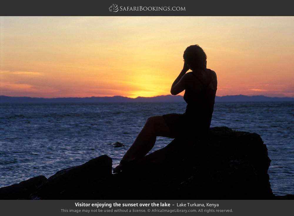 Visitor enjoying the sunset over the lake in Lake Turkana, Kenya