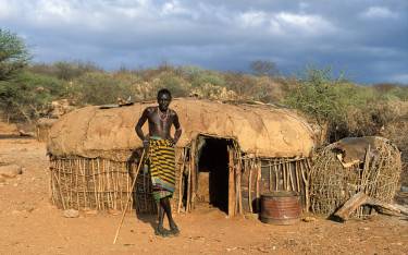 Samburu man in front of his homestead