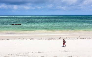 Maasai person walking on the beach