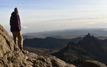 Hiker overlooking a mountainous landscape