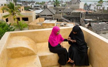 Swahili woman painting hands with henna