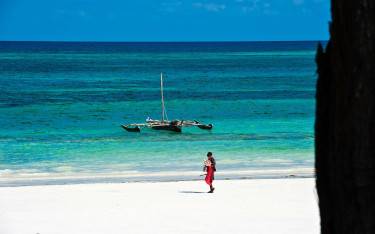 Maasai person walking on the beach in Mombasa