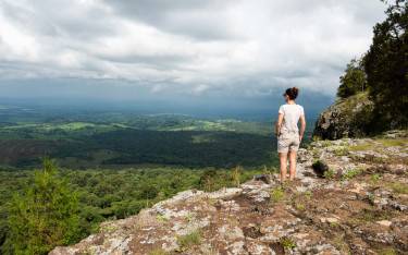 Hiker enjoying the view from Endebess Bluff on Mt Elgon