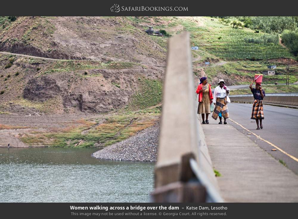Women walking across a bridge over the dam in Katse Dam, Lesotho