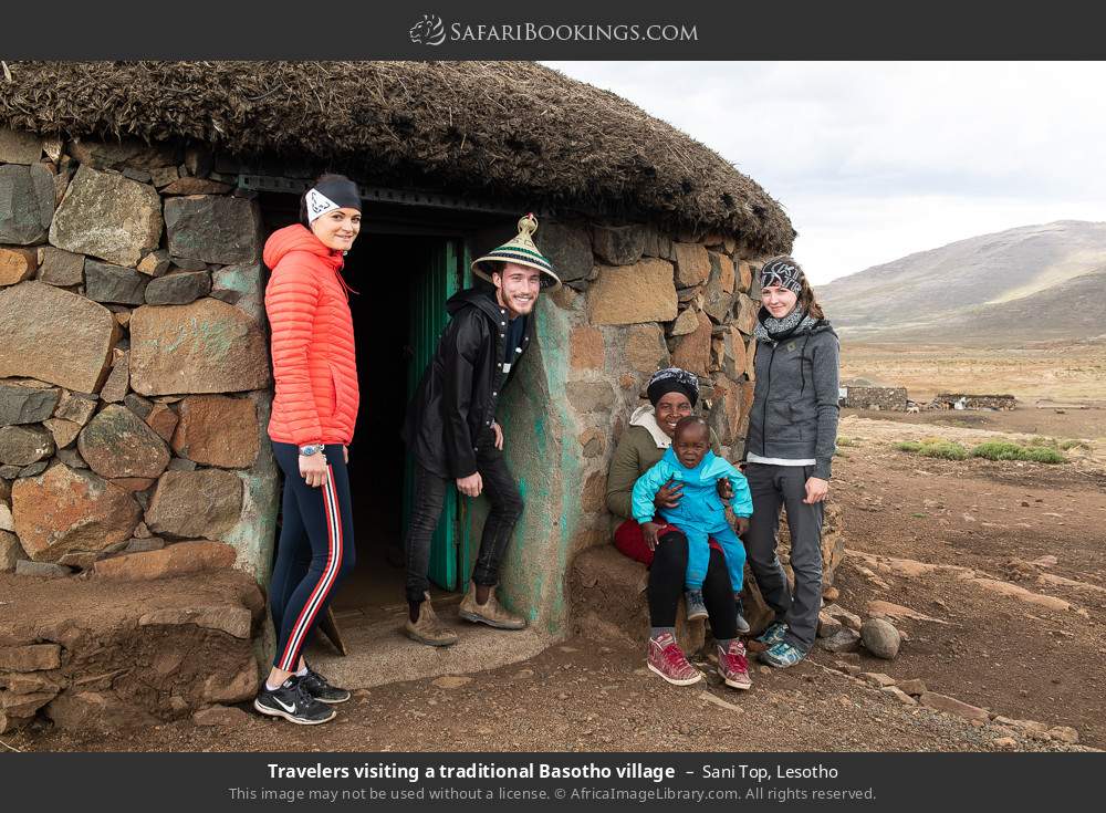 Travelers visiting a traditional Basotho village in Sani Top, Lesotho