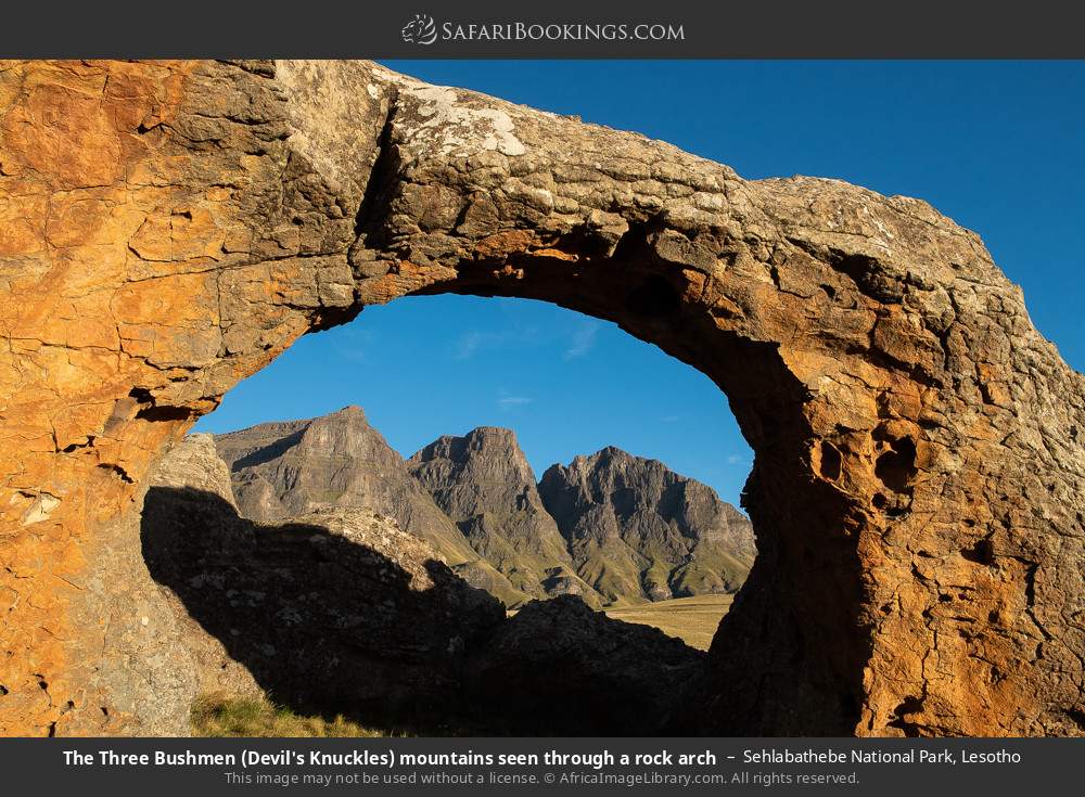 The Three Bushmen (Devil's Knuckles) mountains seen through a rock arch in Sehlabathebe National Park, Lesotho