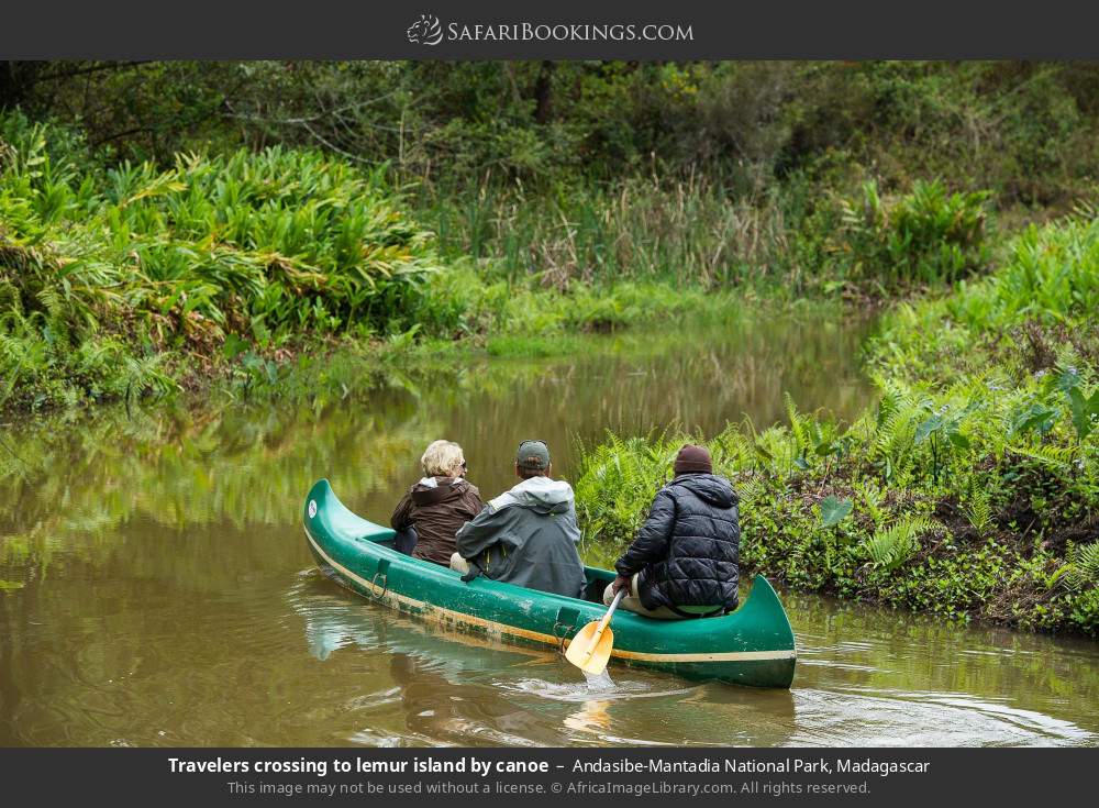 Travelers crossing to lemur island by canoe in Andasibe-Mantadia National Park, Madagascar