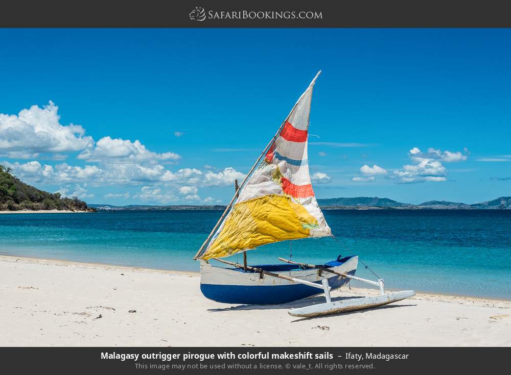 Malagasy outrigger pirogue with colorful makeshift sails in Ifaty, Madagascar