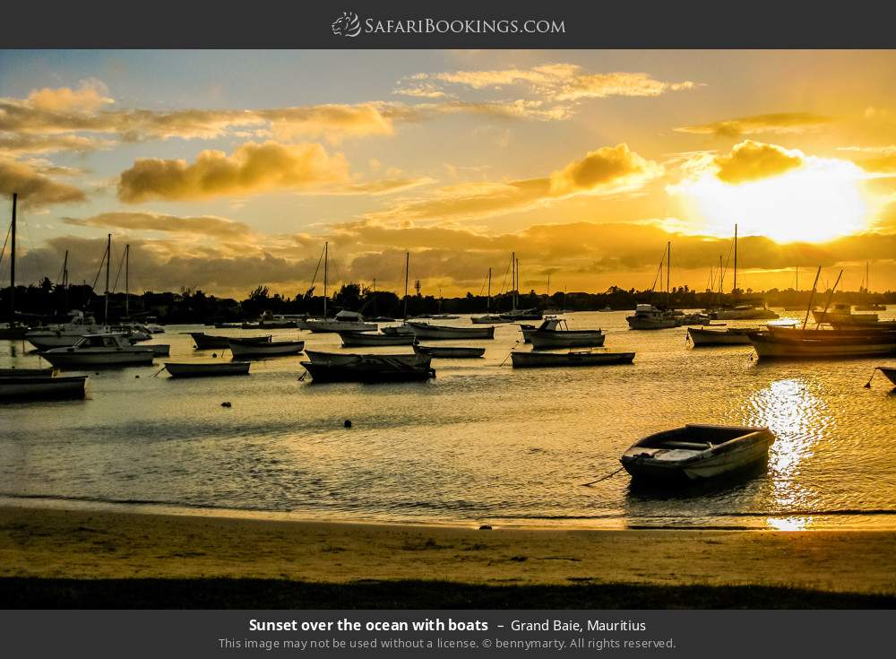 Sunset over the ocean with boats in Grand Baie, Mauritius
