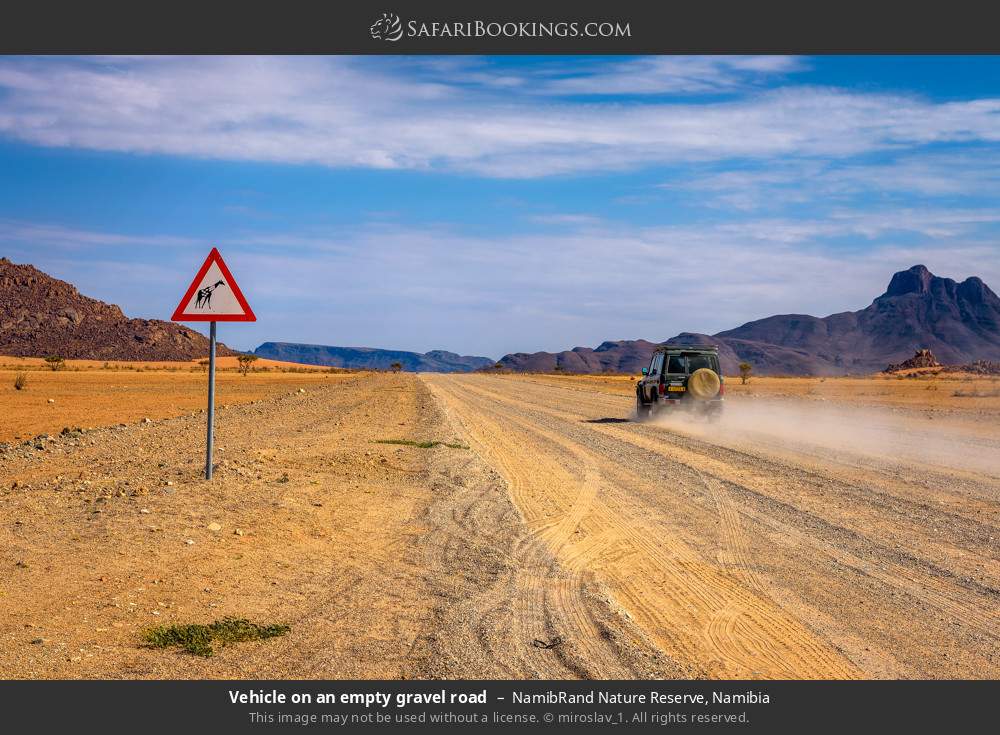 Vehicle on an empty gravel road in NamibRand Nature Reserve, Namibia