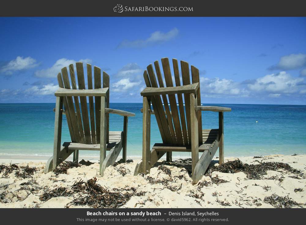 Beach chairs on a sandy beach in Denis Island, Seychelles