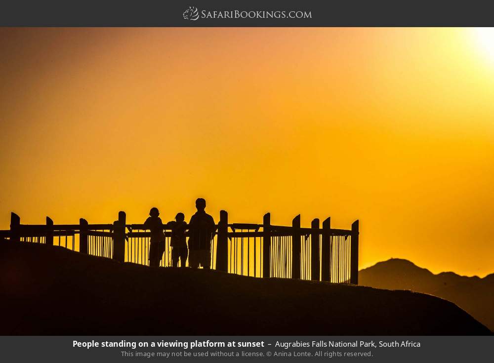 People standing on a viewing platform at sunset in Augrabies Falls National Park, South Africa