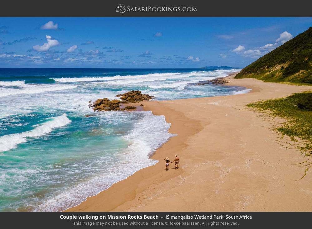 Couple walking on Mission Rocks Beach in iSimangaliso Wetland Park, South Africa