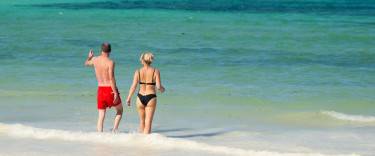 People walking into the sea