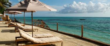 Lounge chairs next to the ocean