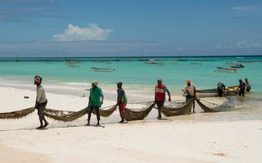 Fishermen pulling nets to shore