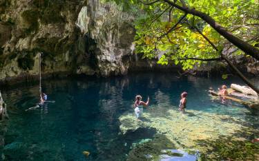 People in the water in Maalum Cave