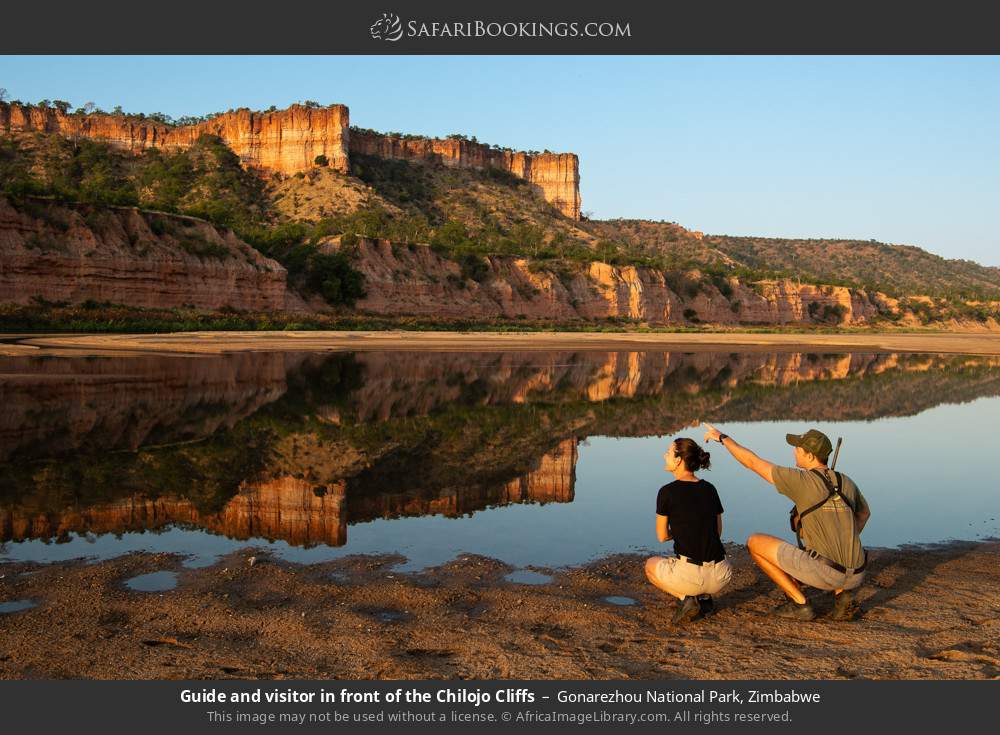 Guide and visitor in front of the Chilojo Cliffs in Gonarezhou National Park, Zimbabwe