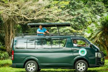 Peter Amanya and our guide in the safari van