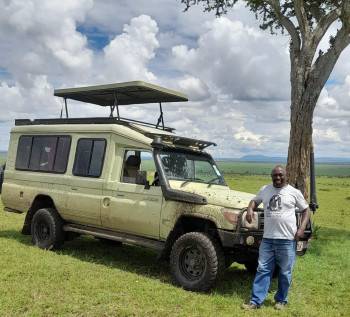 Tour guide taking a break during game drive 