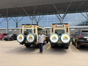 Our Director standing infront of our vehicles