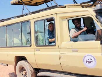 Our tour guide with our clients in a wild safari 